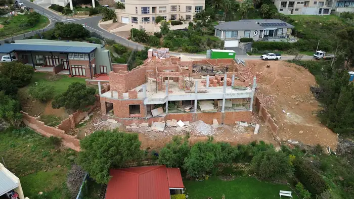 House Makhene at brickwork stage, with the first floor slab cast and the columns standing