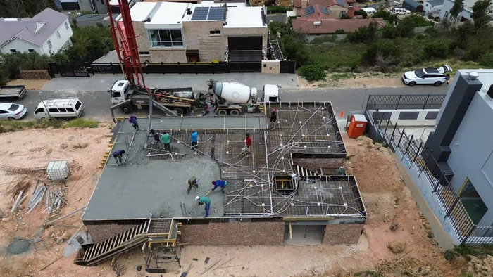 The second floor slab going down, half of it cast and the rest still open reinforcing over the shuttering